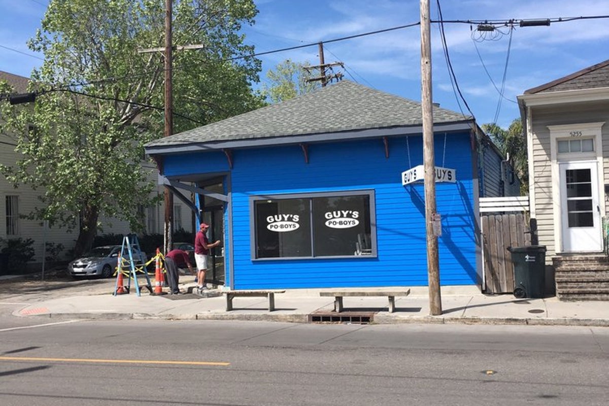 Guy's Po-Boys storefront, a blue corner building on Magazine Street